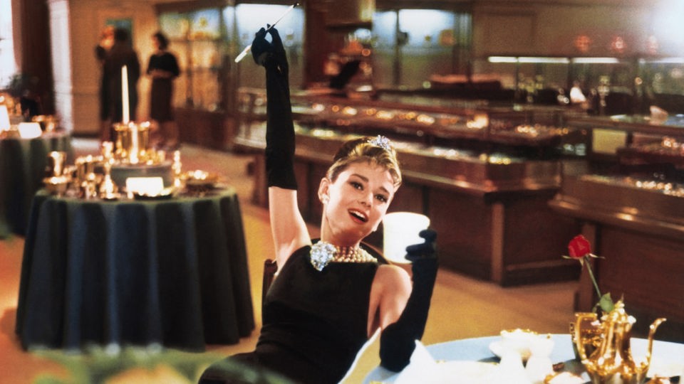 Audrey Hepburn als Holly  Golightly frühstückend bei Tiffany (Filmfoto)