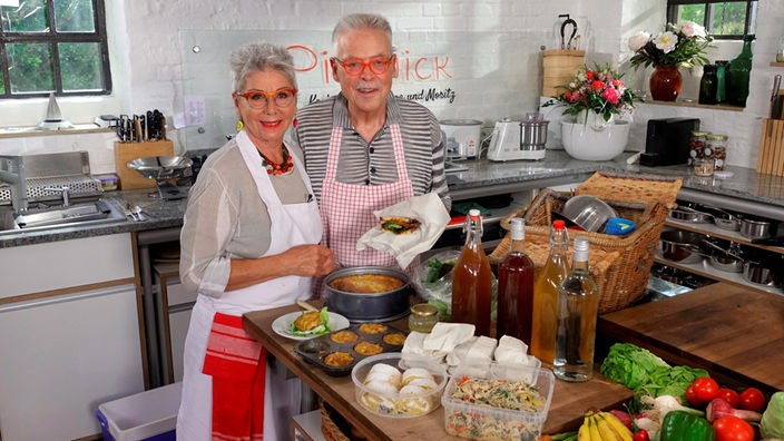 Martina und Moritz bereiten in ihrer Küche Gerichte zum Mitnehmen zu