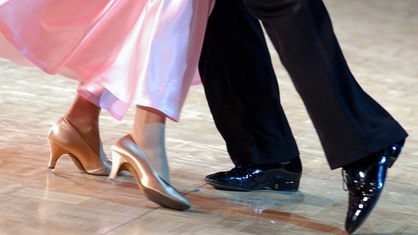 Beine eines tanzenden Paares in eleganter Kleidung